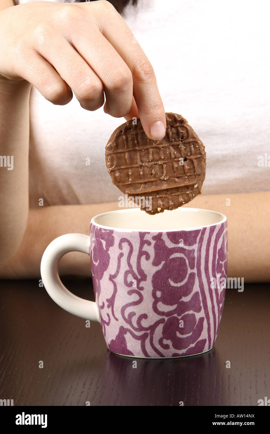 Young Woman Dipping Cookie in Tea Model Released Stock Photo Alamy