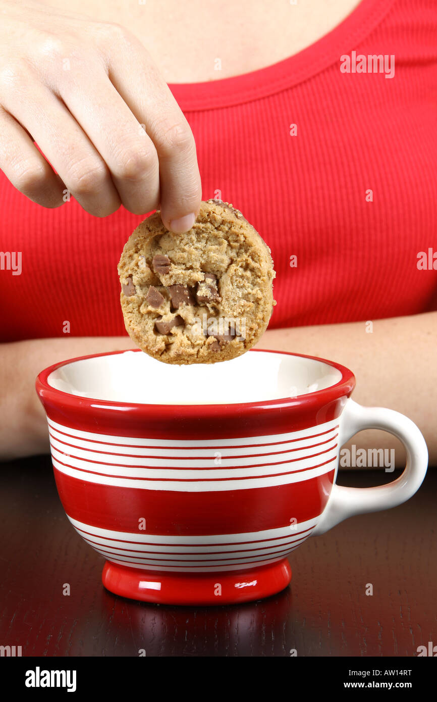 Young Woman Dipping Cookie in Tea Model Released Stock Photo Alamy