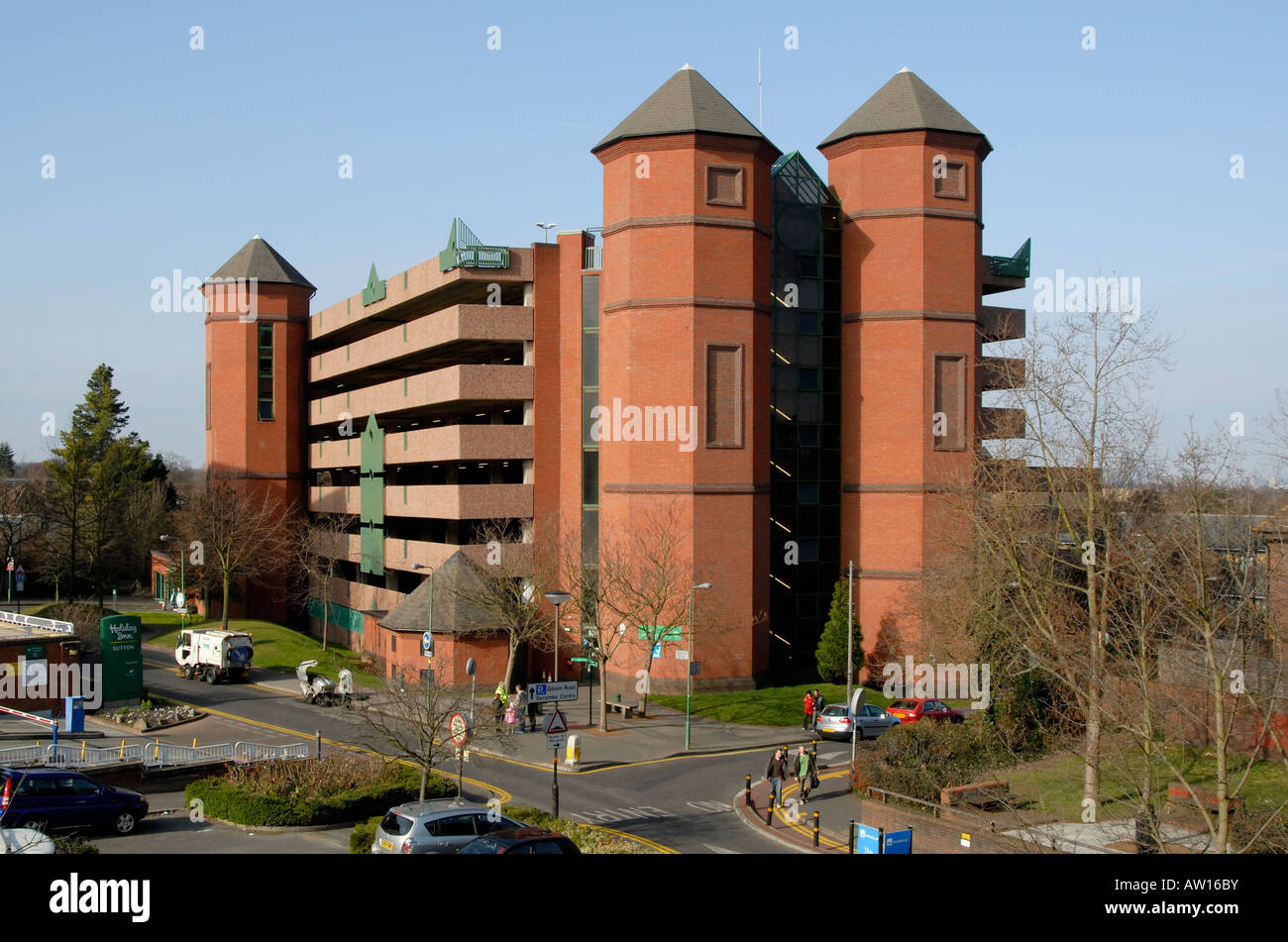 Red brick multi storey car park with turrets overlooking suburban Sutton, southwest London, England Stock Photo