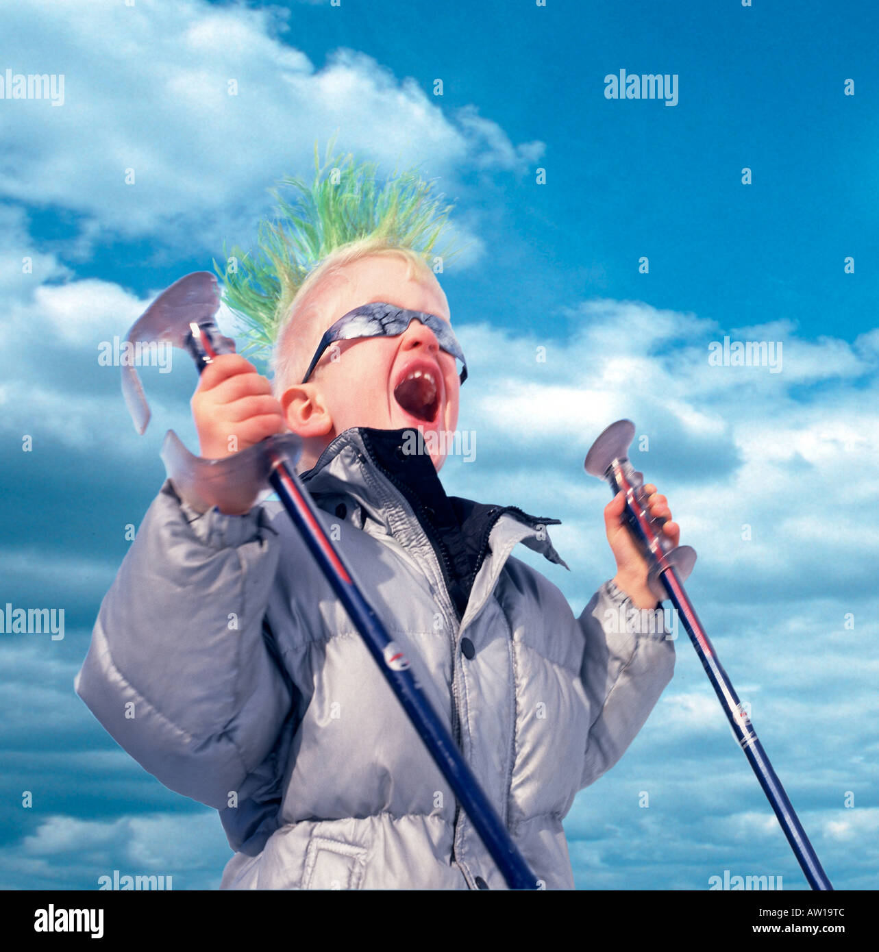 Young boy Screaming with Green Mohawk Haircut and Ski Poles Stock Photo
