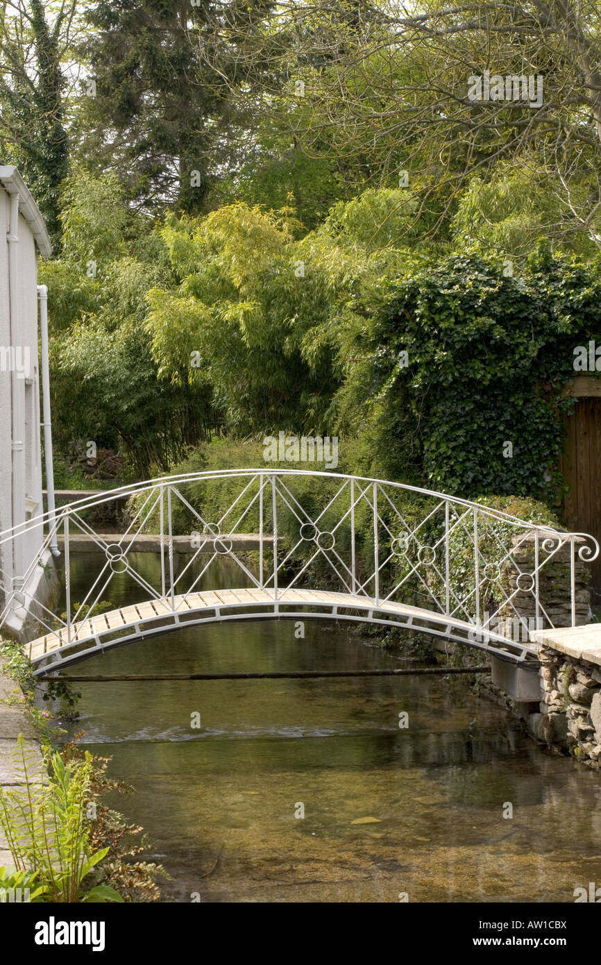 UK gardens. Stream and footbridge garden feature. Stock Photo