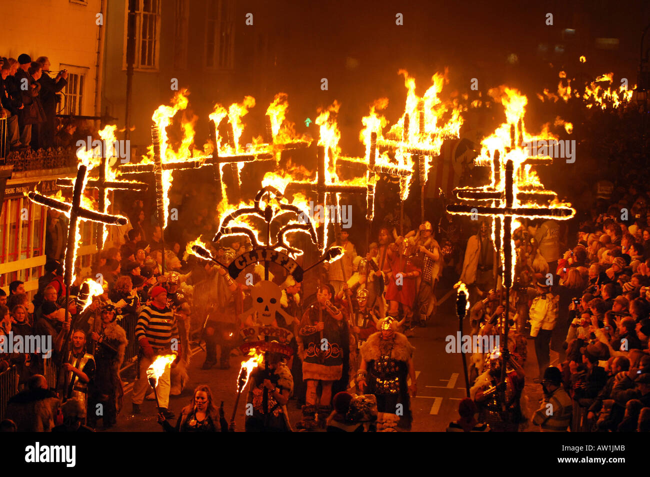 Burning crosses form part of a breathtaking parade of fire and fireworks on bonfire  night in Lewes, England. Stock Photo