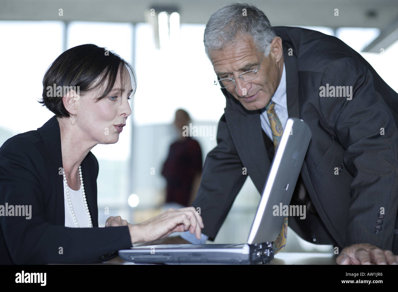 Business man and business woman discussing edits on a notebook Stock ...