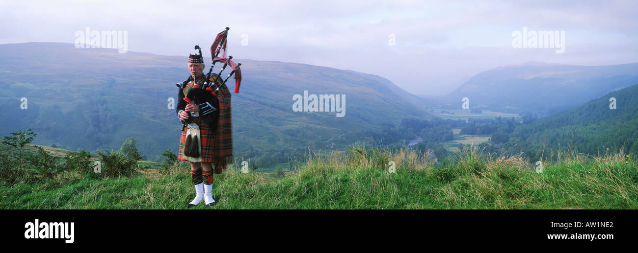 Bagpiper at Loch Broom in Scottish highlands Stock Photo
