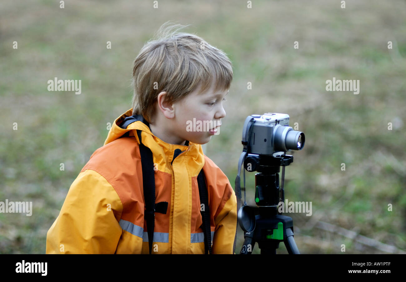 Boy taking photos with a digital camera Stock Photo - Alamy