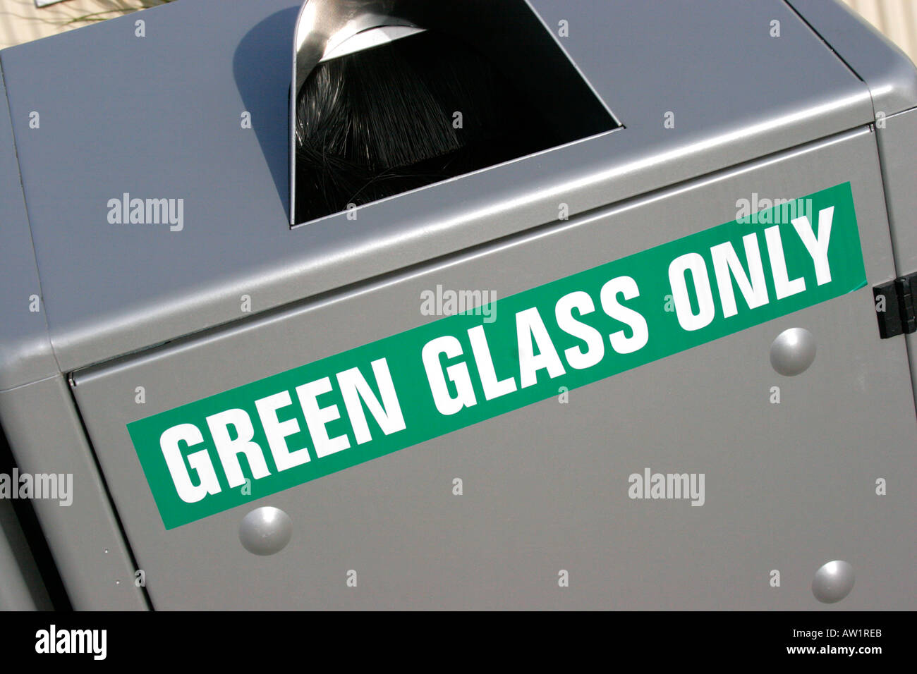 Green glass bottle recycling bin Stock Photo - Alamy