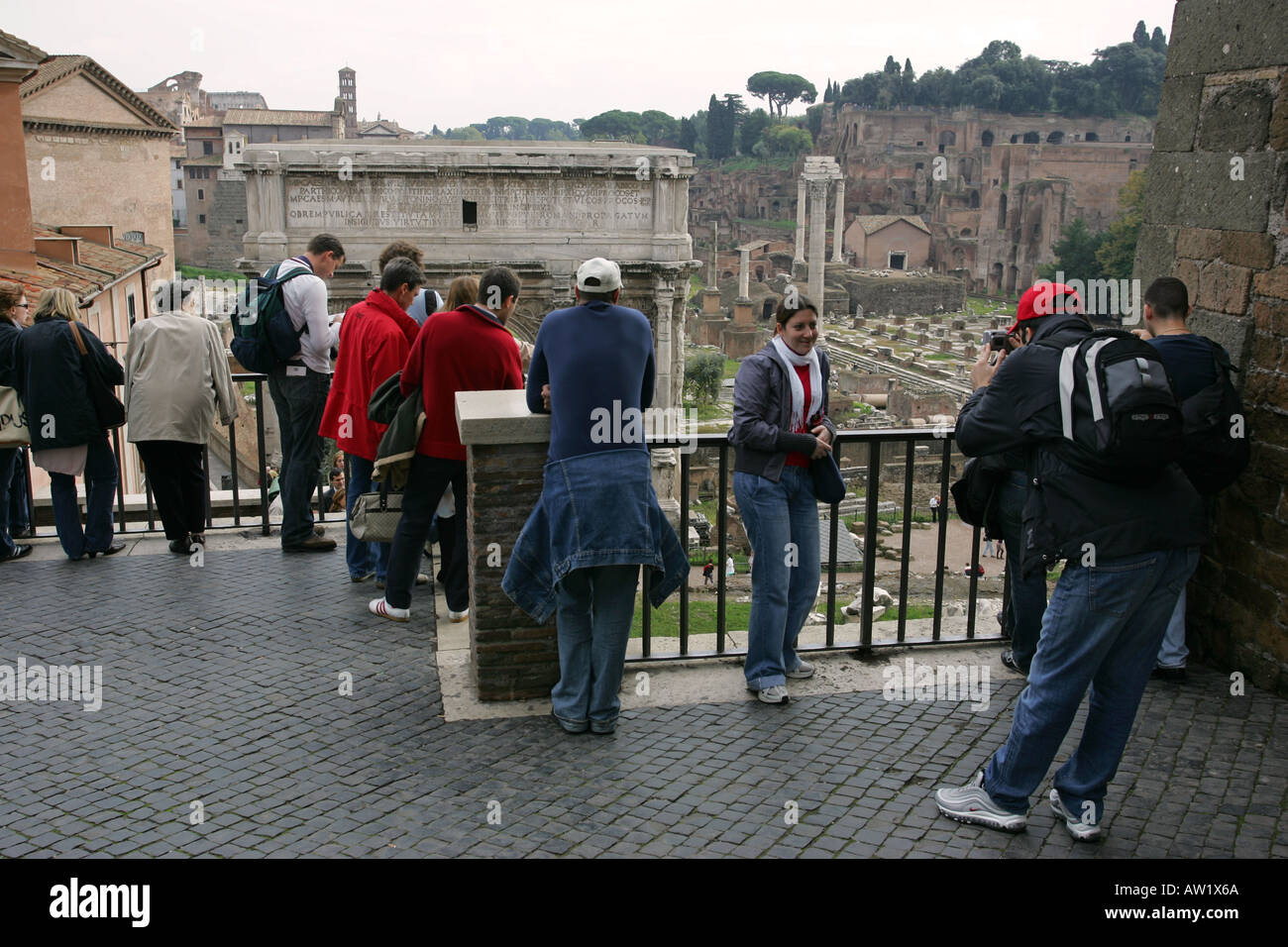 Toursits take photographs of each other in front of famous Rome visitor attraction the Roman Imperial Forum, Italy Europe Stock Photo