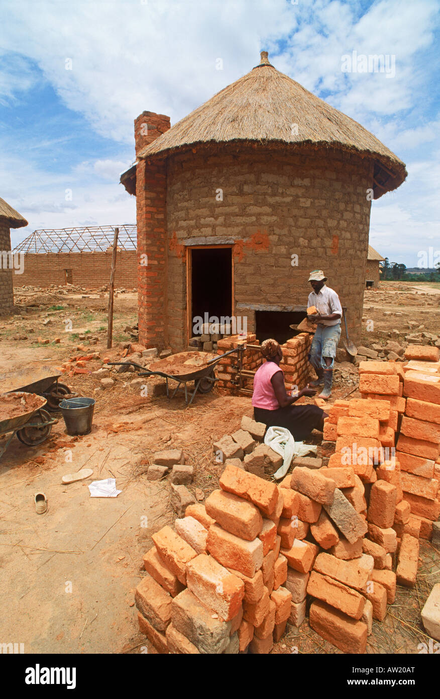 Africans building small scale drying huts for tobacco leaves on tobacco plantation in Zimbabwe Stock Photo