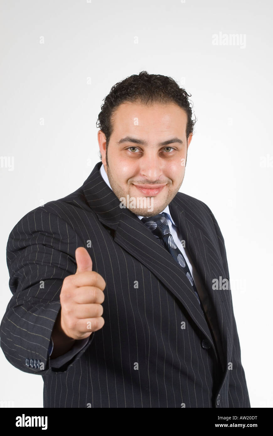 Happy business man thumbs up smiling Stock Photo - Alamy