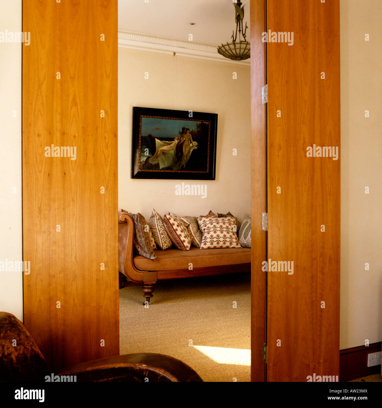 view through folding double doors on to a sofa and cushions Stock Photo