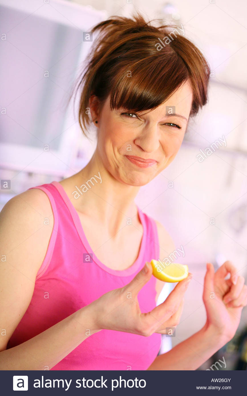 woman biting a lemon Stock Photo