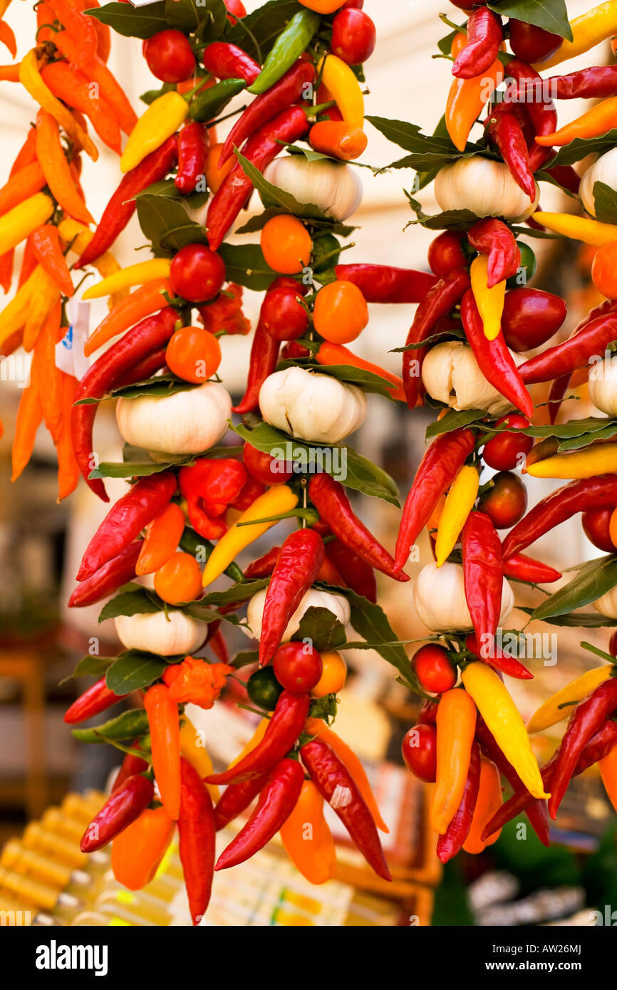 peppers and garlic hanging outside a market stall in venice italy Stock ...
