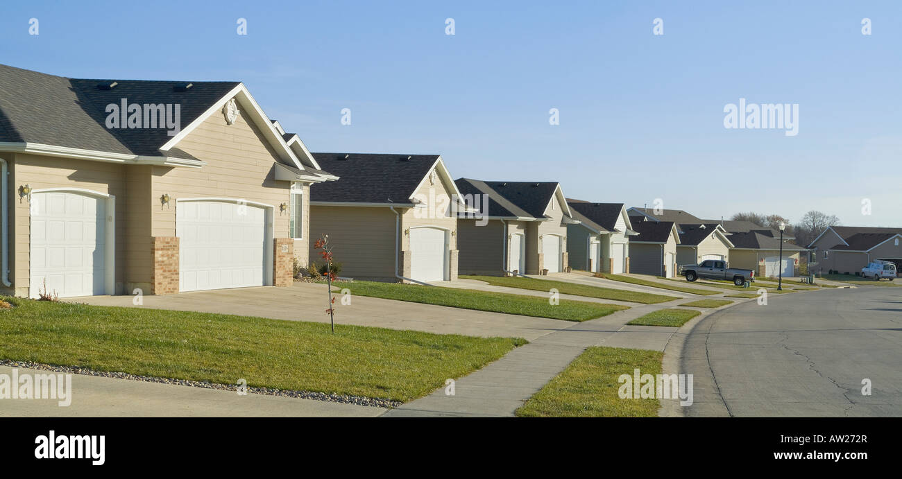 Neighborhood Row Of Suburban Homes And Garages, Ireton Iowa, USA Stock Photo