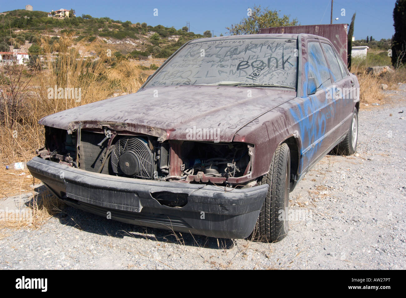 Abandoned Mercedes Benz 190E, left at the road, greece 2006. Stock Photo