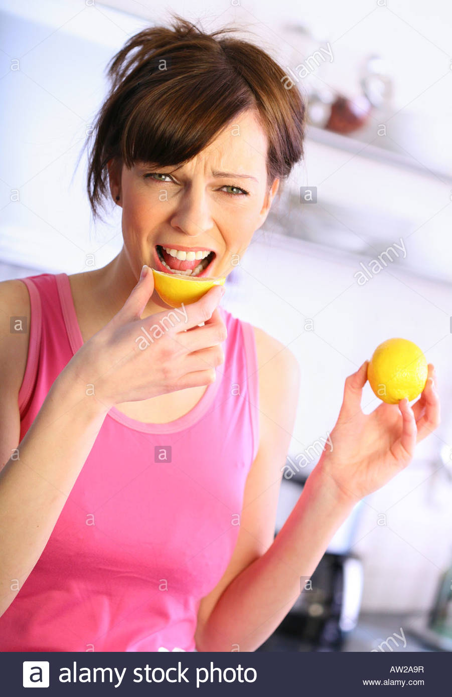 woman eating a lemon Stock Photo