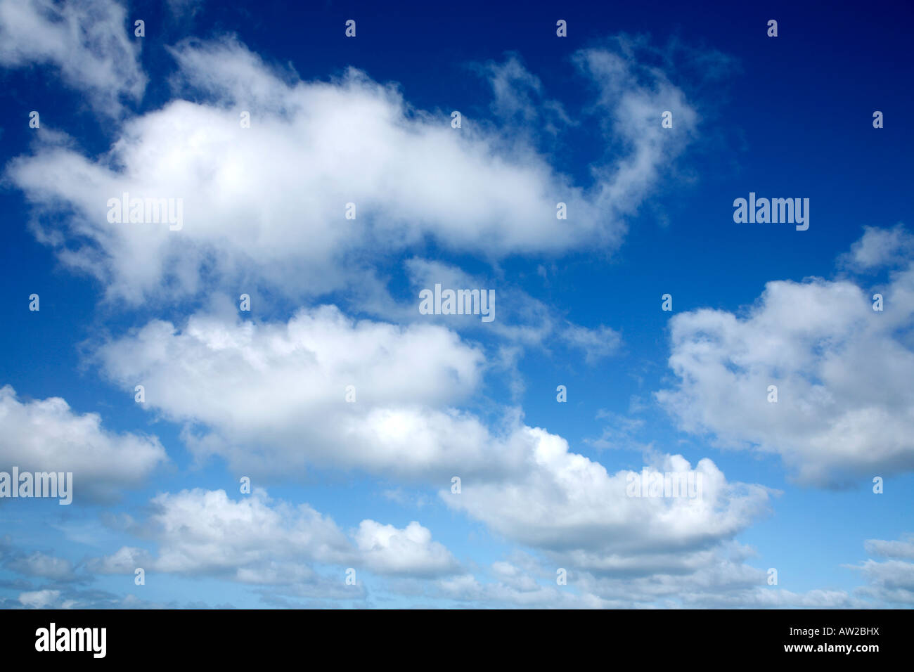 White clouds and blue sky over the Atlantic ocean in Cornwall, UK Stock Photo