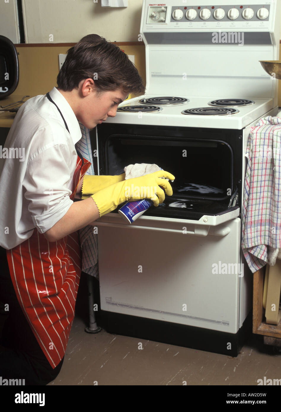 Boy cleaning electric cooker Stock Photo Alamy