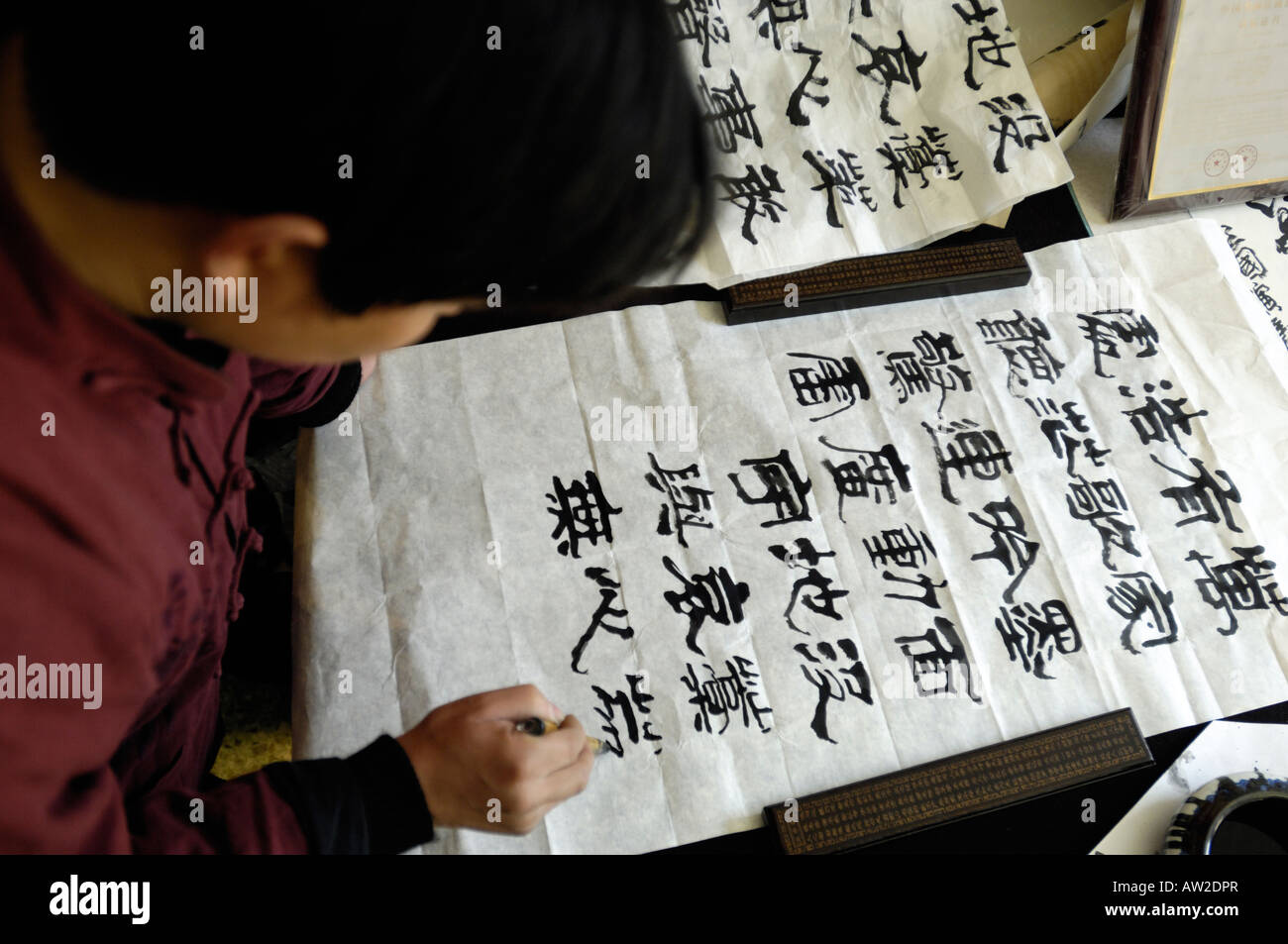 An expert in the art of calligraphy writing with Chinese writing brush at Liulichang Beijing China. 03-Mar-2008 Stock Photo