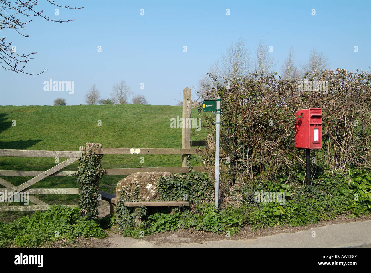 English village footpath with stile and Victorian postbox Stock Photo