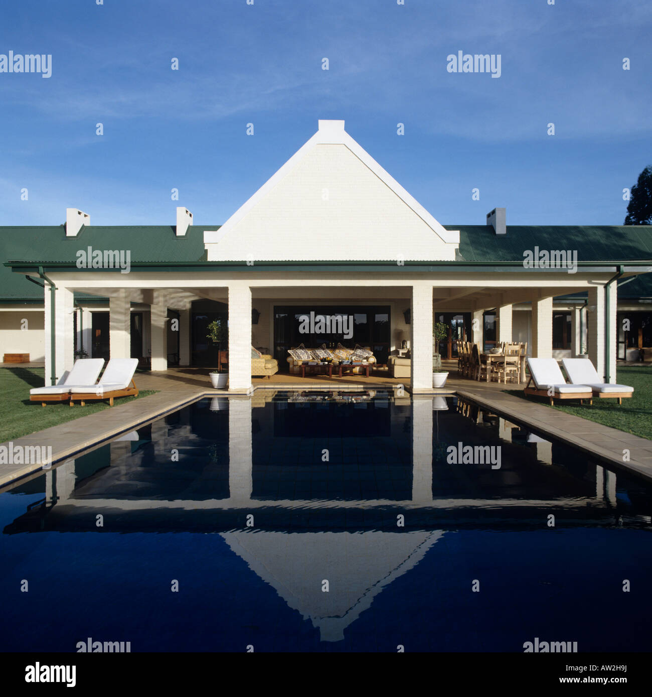 front elevation of a Zimbabwean farmhouse across swimming pool Stock