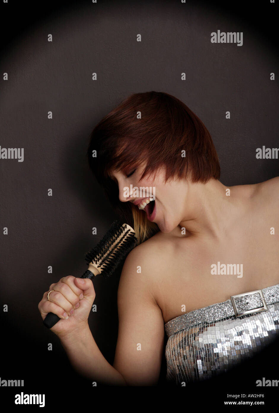 Girl singing into hairbrush Stock Photo - Alamy