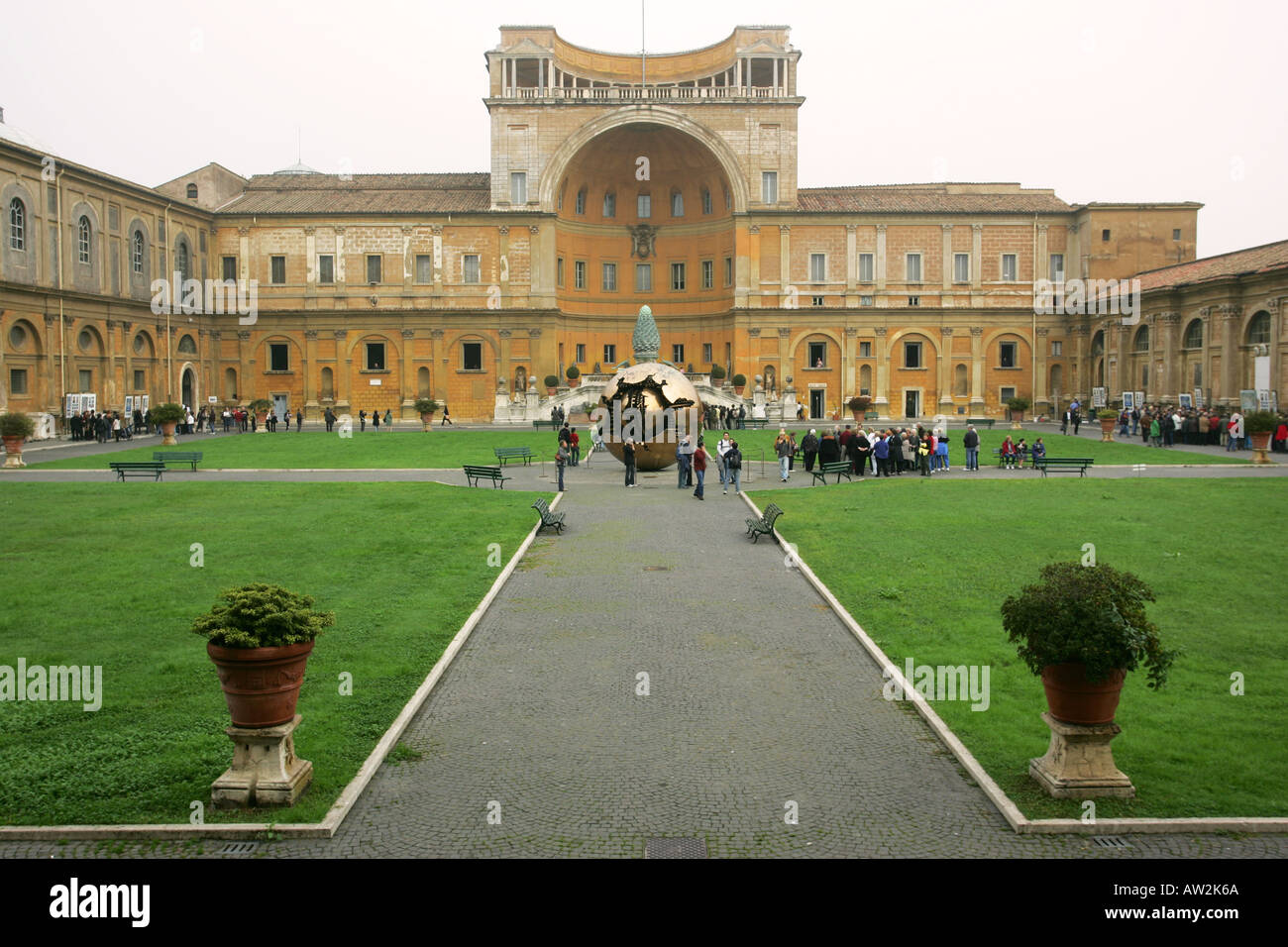 The Sfera Conserva sculpture is surrounded by sightseeing tourists in the Vatican City Museums courtyard Rome Italy Europe Stock Photo