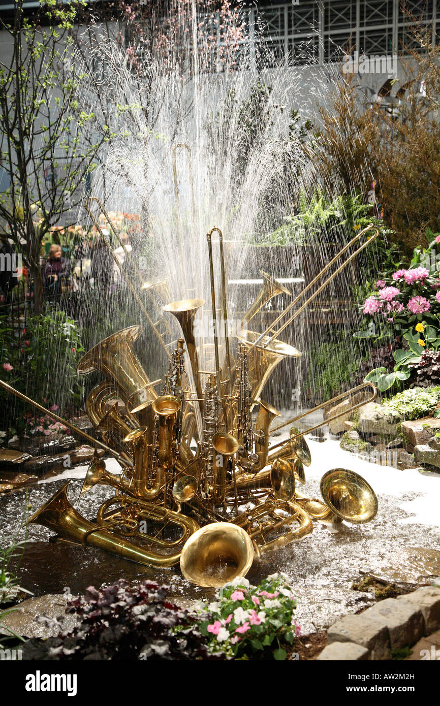 Large fountain constructed from many brass musical instruments shoots large  spray of water into air. Philadelphia flower show Stock Photo - Alamy