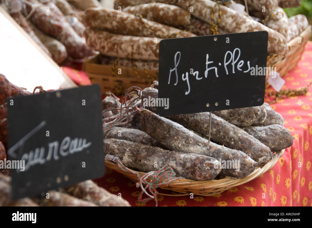 Close up of a basket of Myrtilles sausages, salami, chorizo, on sale in a market in France, blueberry flavoured Stock Photo