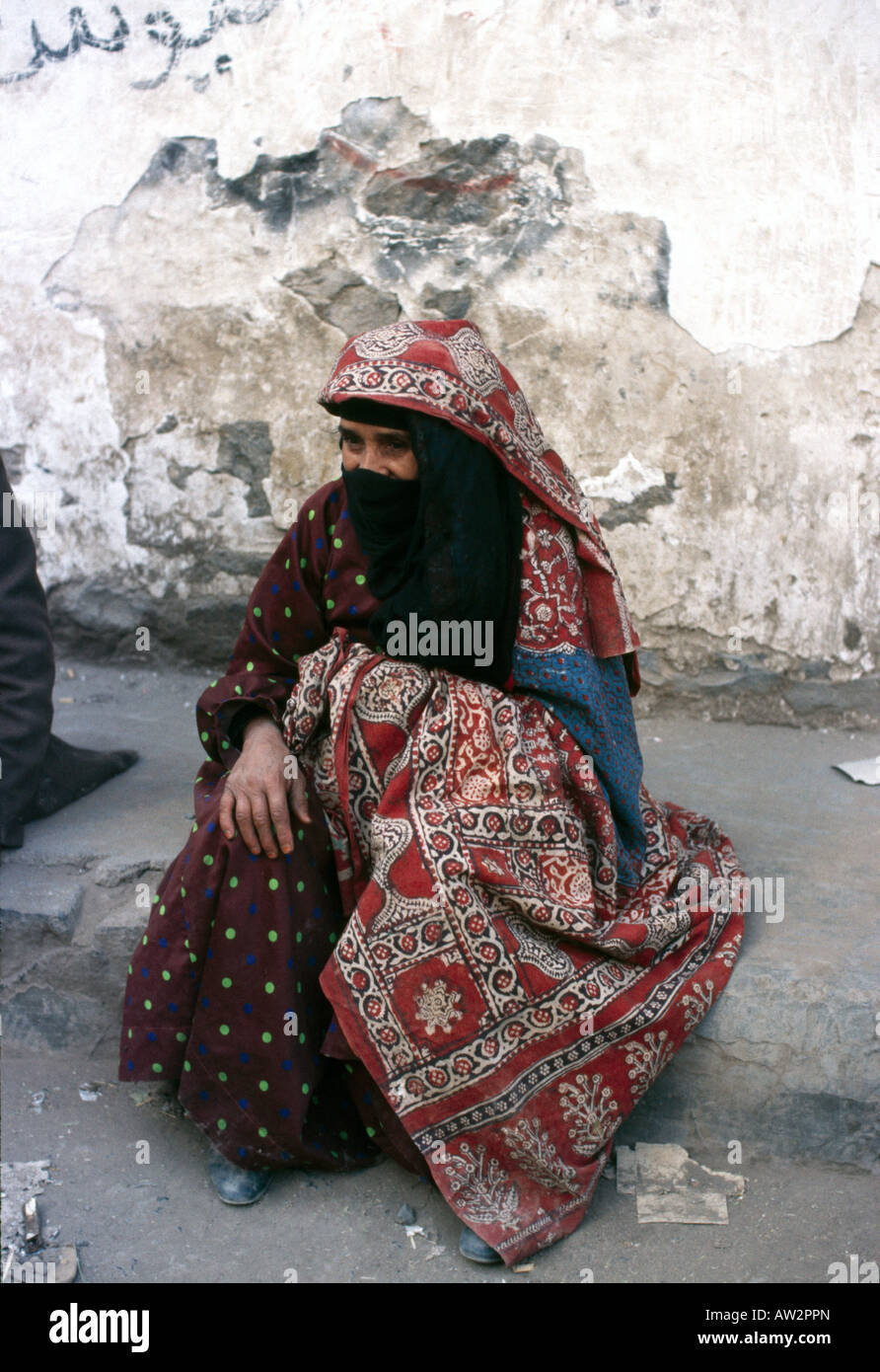 Sanaa Yemen Veiled Woman Sitting On Kerb Stock Photo