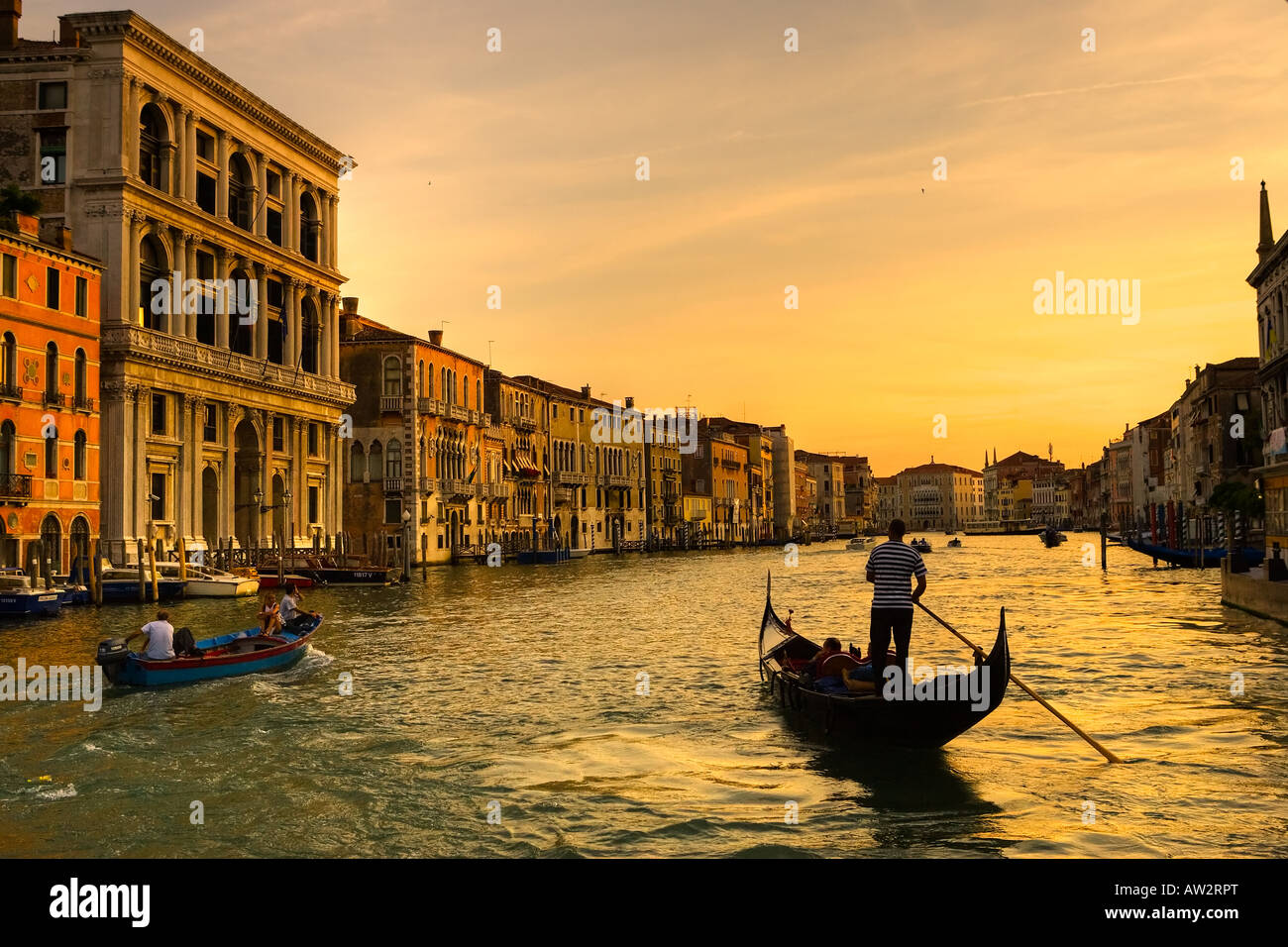 Sunset over the Grand Canal in Venice with silhouette of gondolier in ...