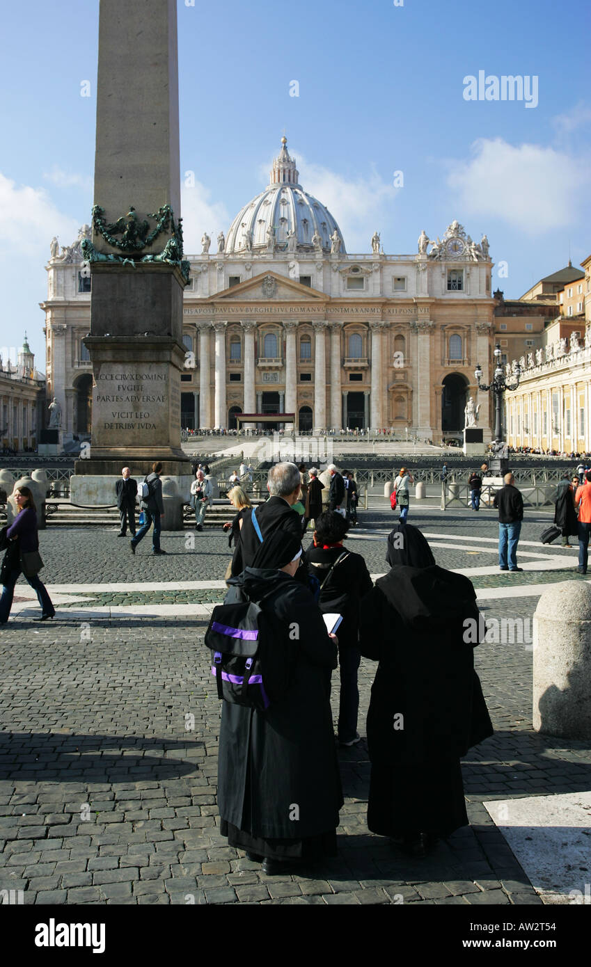 Catholic Nuns Priest read tourist map guide book visiting St Peters Square Basillica Vatican City Rome Italy Europe EU pilgrima Stock Photo