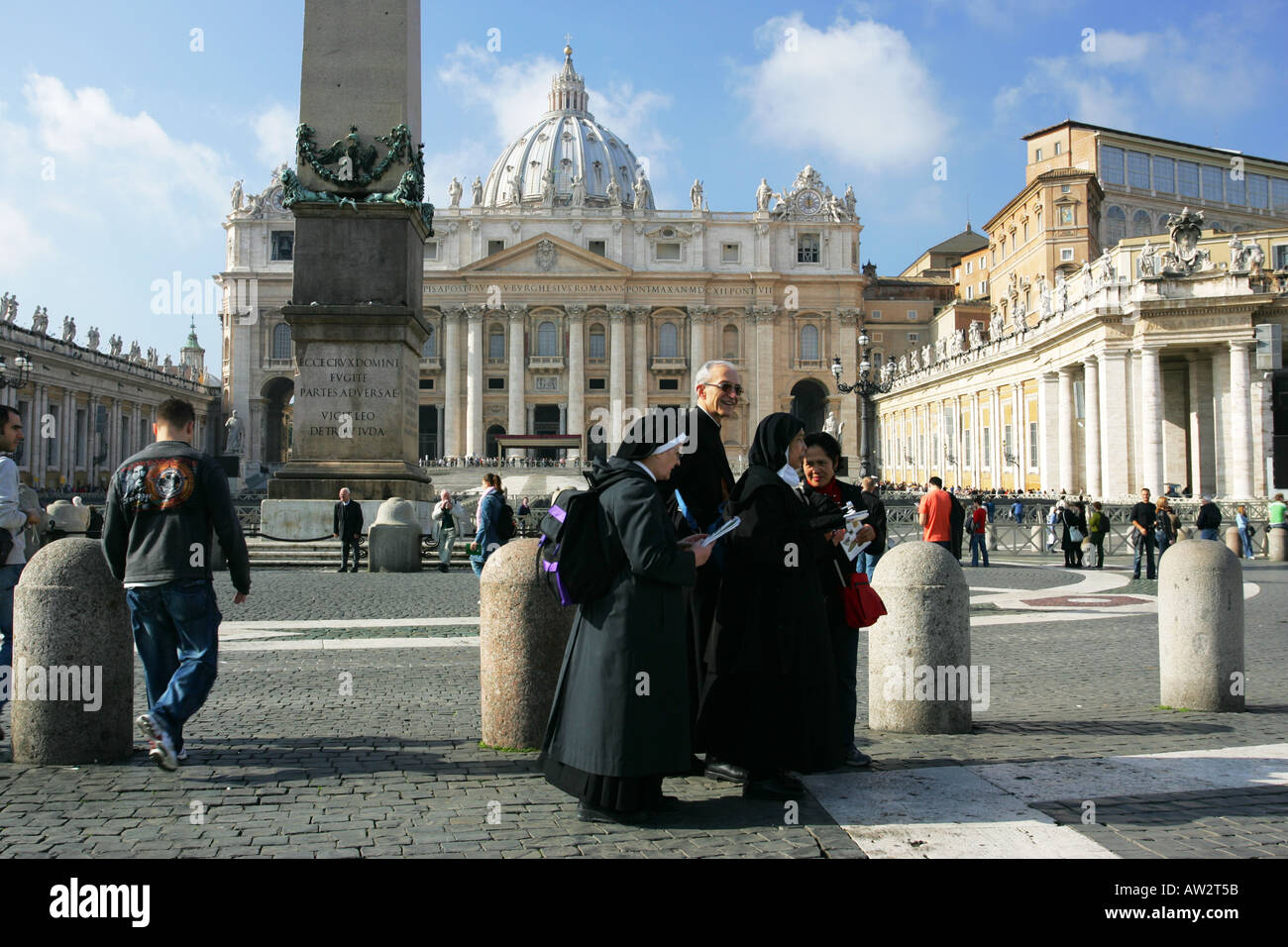 Catholic Nuns and a Priest read a tourist map guide book visiting St Peters Square Vatican City Rome Italy Europe EU Stock Photo