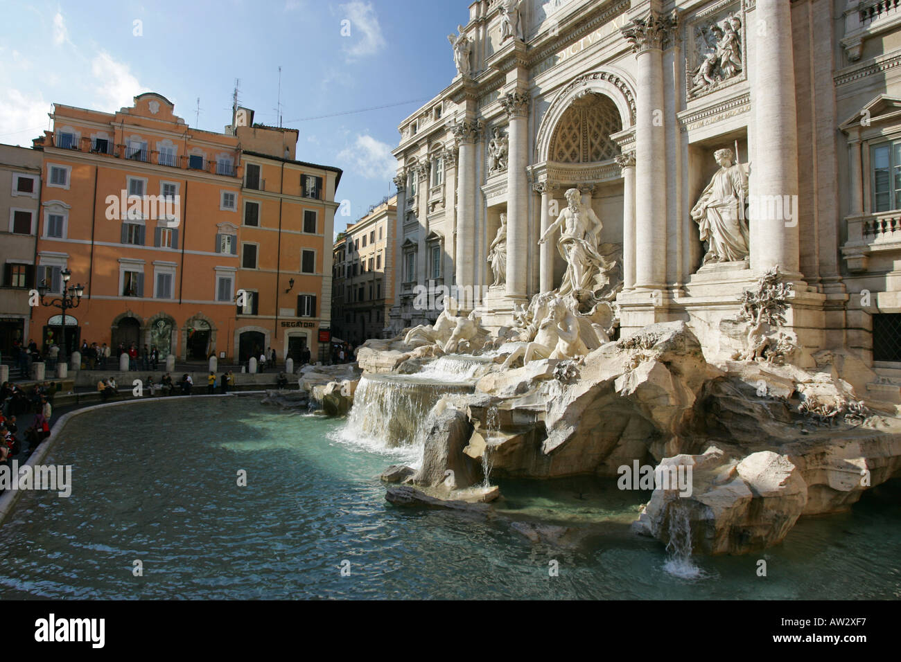 Closeup detail the famous landmark tourist attraction the Trevi Fountain with white marble statues Neptunes chariot Rome Italy Stock Photo