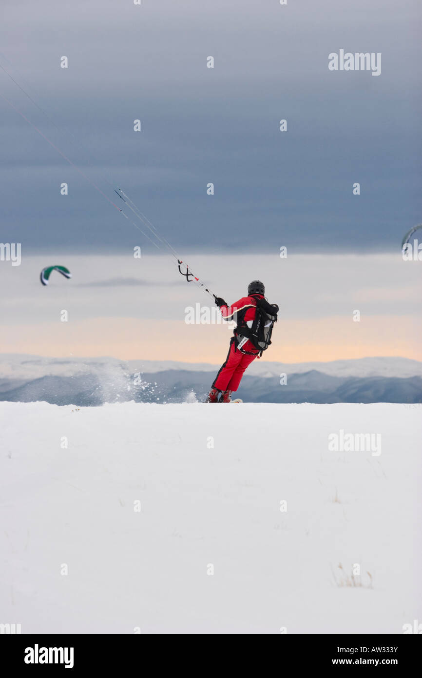 Man kiteskiing near Boise Idaho with Owyhee Mountain range on the horizon MR Stock Photo