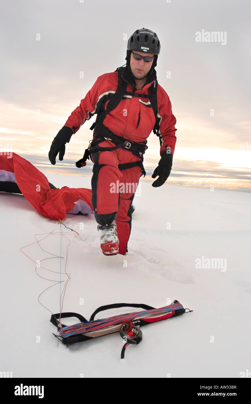 Man preparing equipment for winter kiteskiing session MR Stock Photo