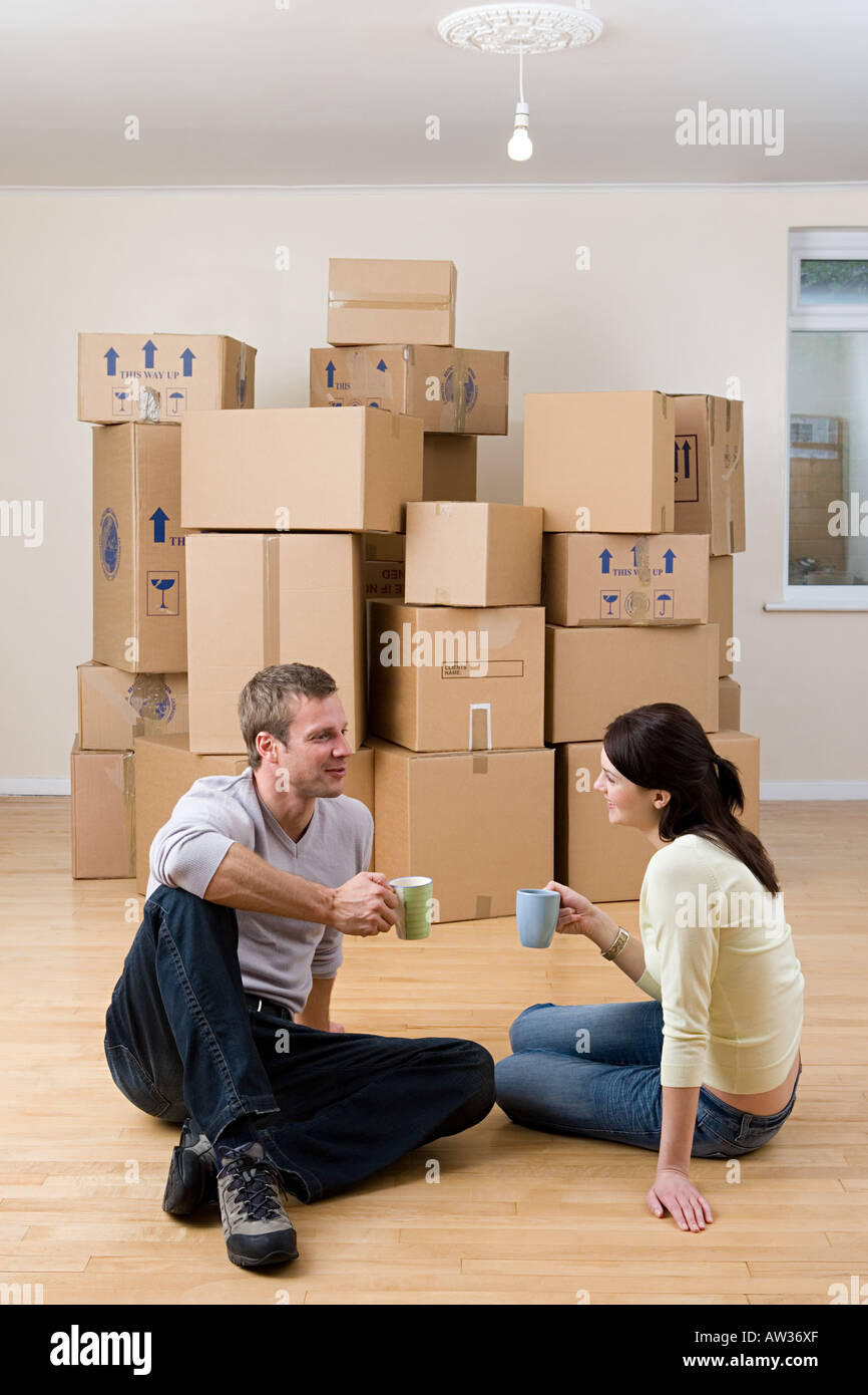 Couple taking a break from unpacking Stock Photo
