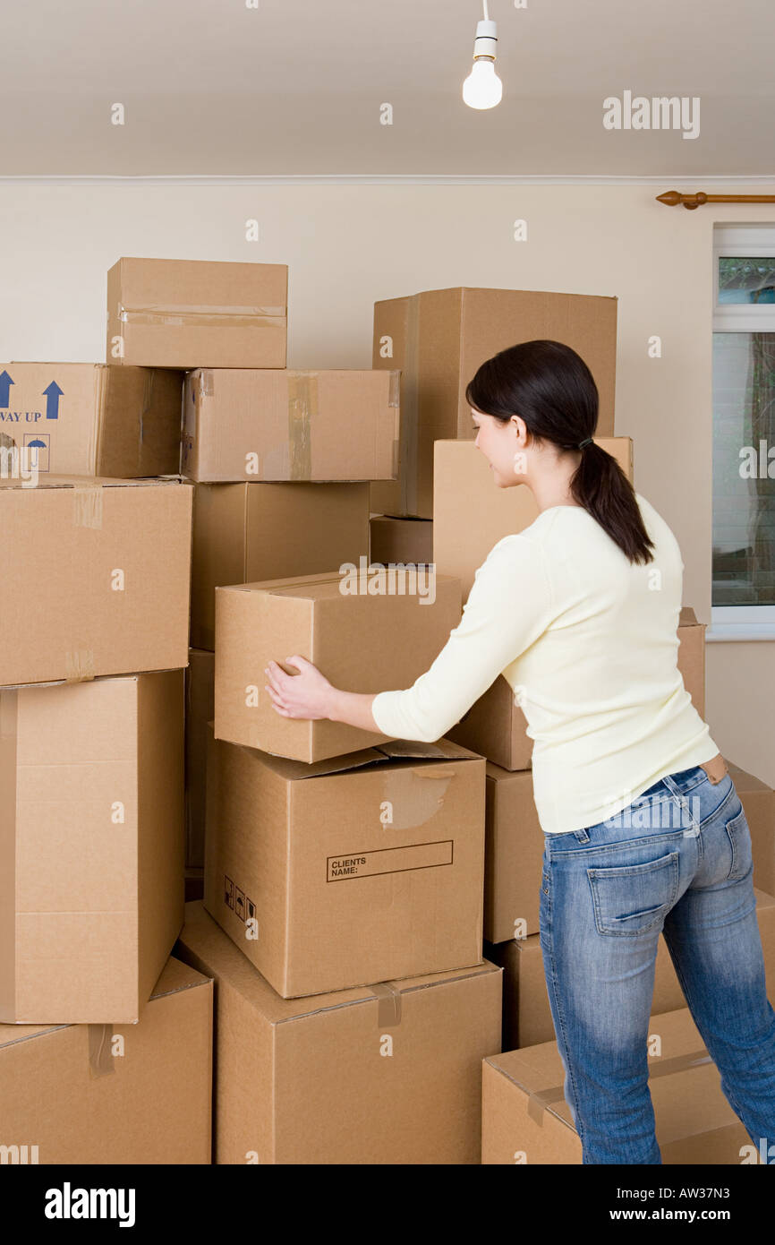 Woman stacking cardboard boxes Stock Photo Alamy