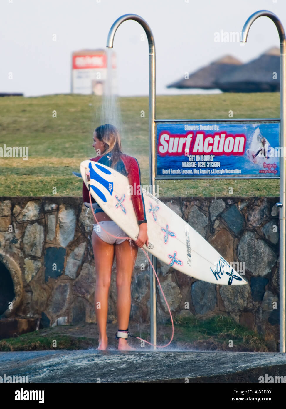 Surfer showering at the beach after leaving the water Stock Photo Alamy