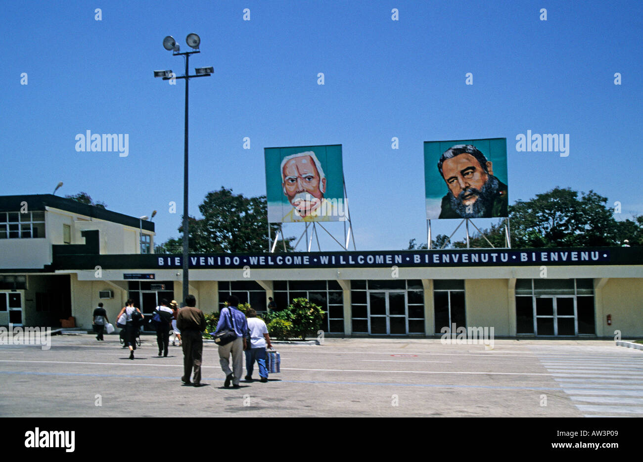 Embarking at airport with welcome sign and poster of Fidel Castro Cuba Stock Photo