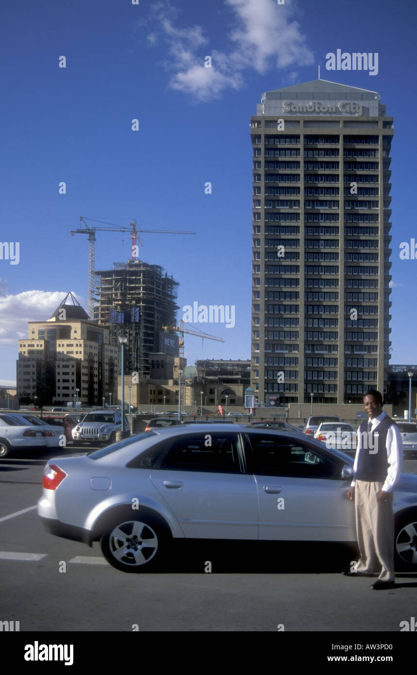 Young black man outside his Audi A4 car in the car park of Sandton City Johannesburg South Africa Stock Photo