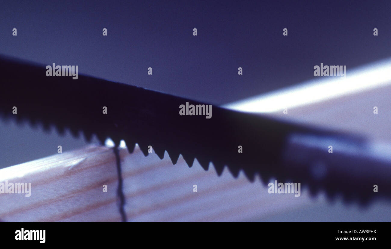 Close up of a thin piece of wood being cut to size with a coping saw Stock Photo Alamy