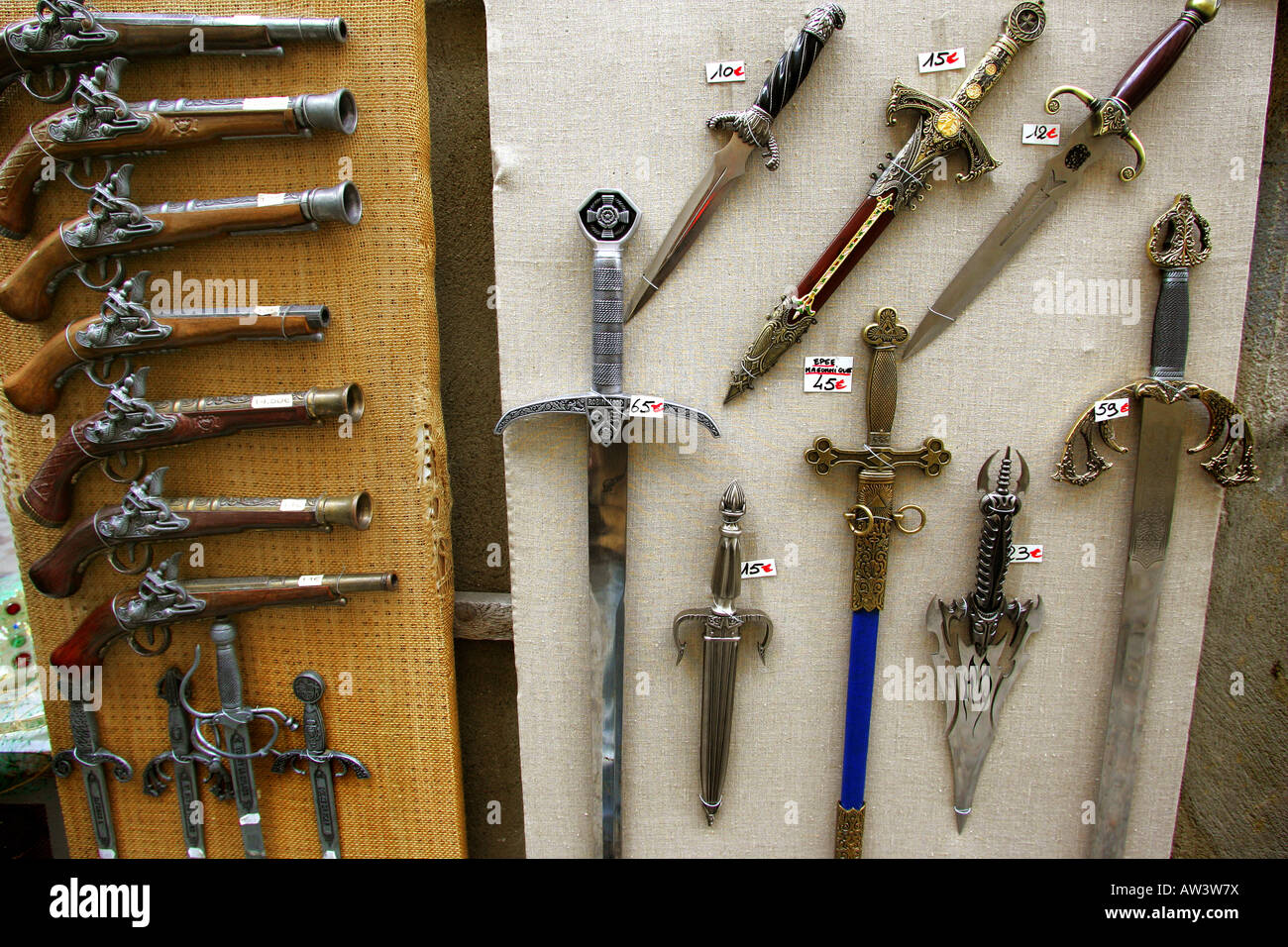 Replica medieval swords and eighteenth century pistols on sale in France. Stock Photo