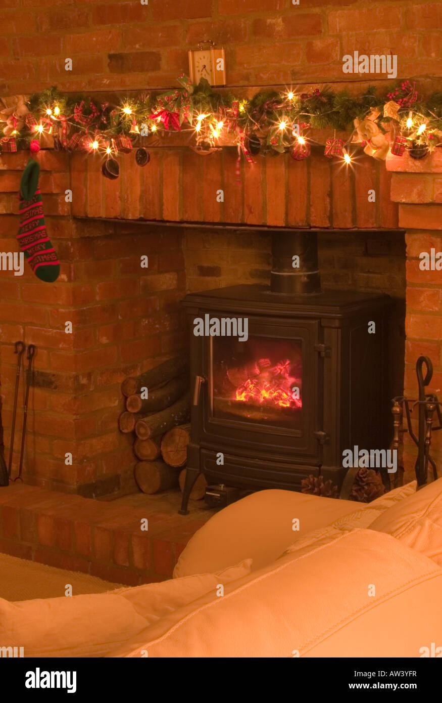 Christmas Lights And Decorations In A Sitting Room With A Log