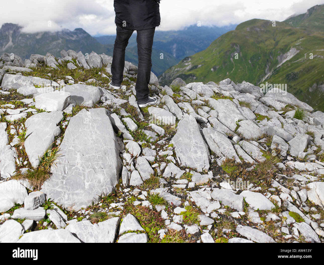 Legs of a woman on top of a mountain. Stock Photo
