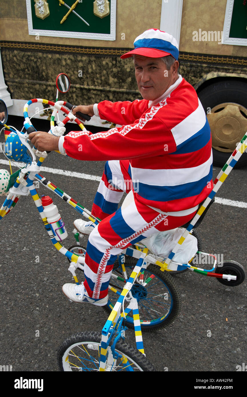 Man riding three wheel bike with streering wheel at carnival on Gran Canaria Stock Photo