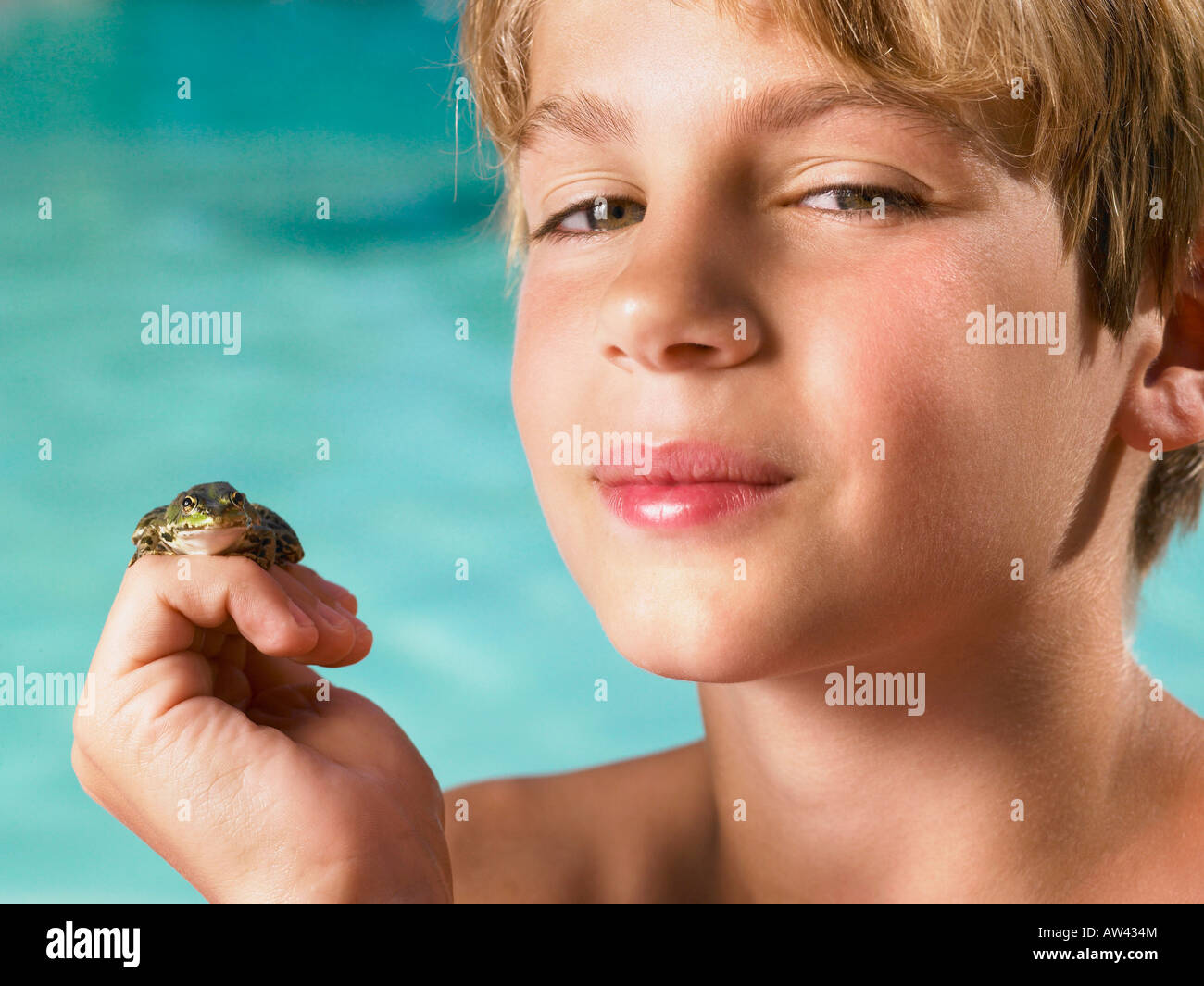 Boy holding a frog in his hand. Stock Photo