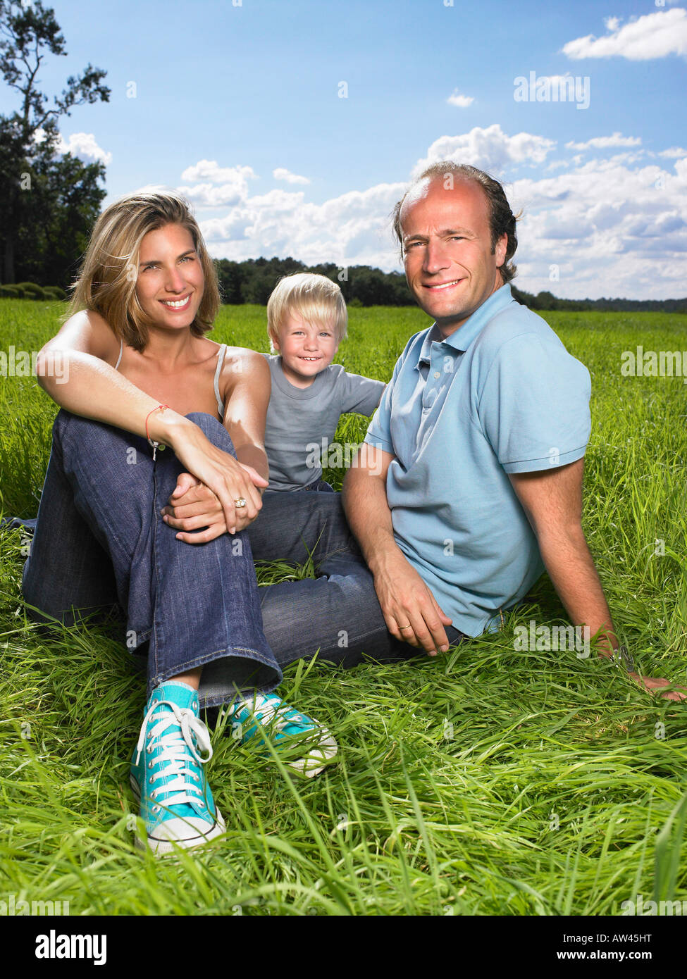 Family enjoying a good time in a field. Stock Photo