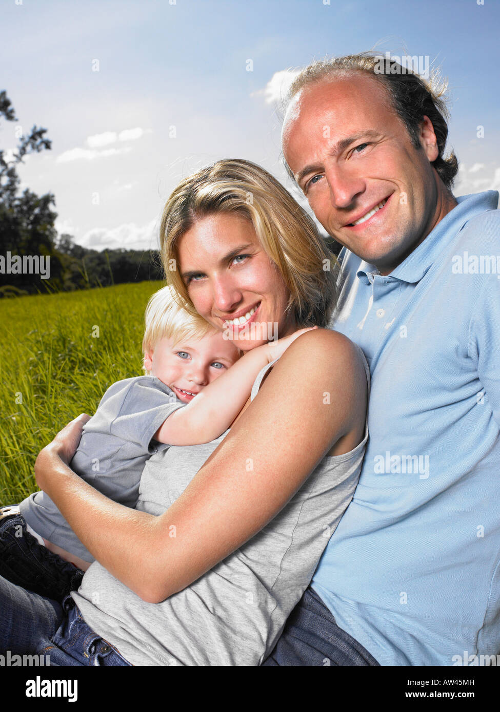 Family enjoying a good time in a field. Stock Photo