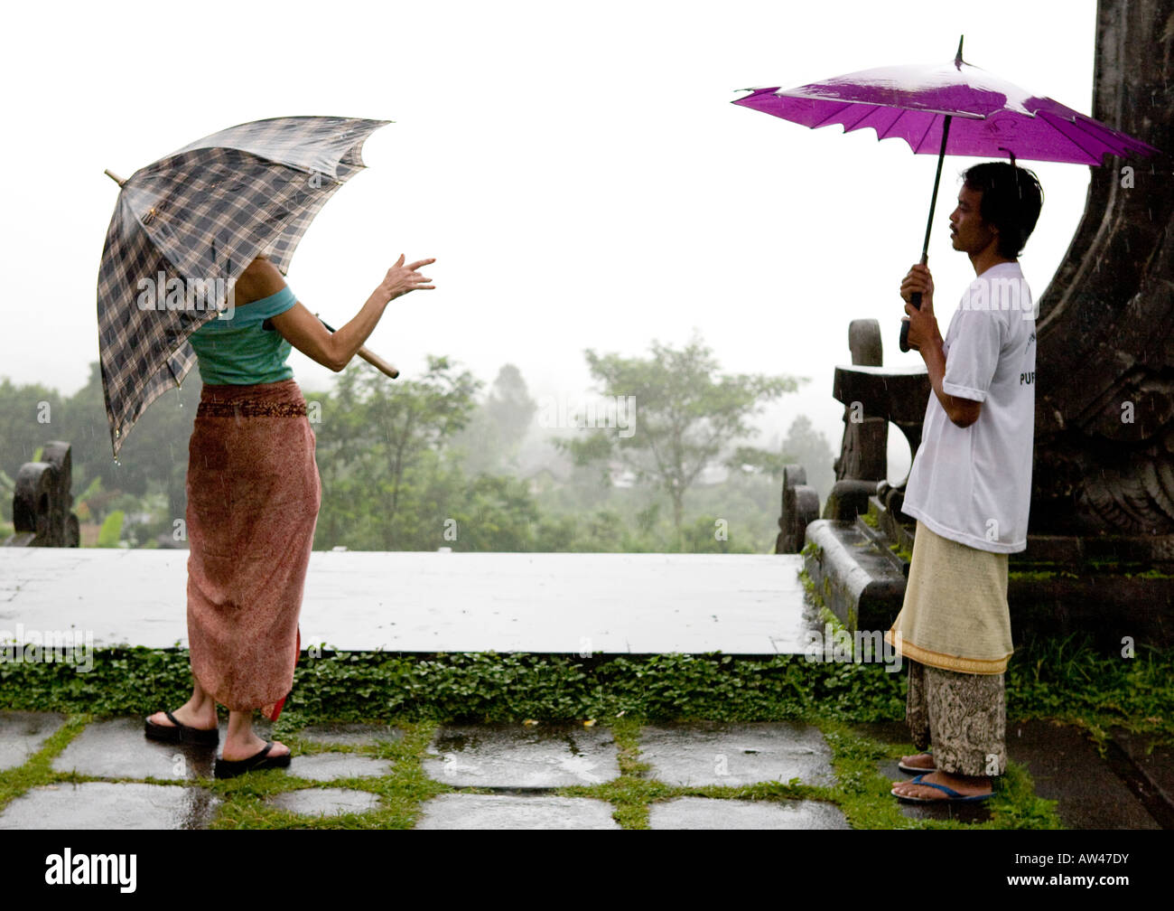 People Carrying Umbrellas At The Pura Besakih Temple Bali Indonesia Stock Photo