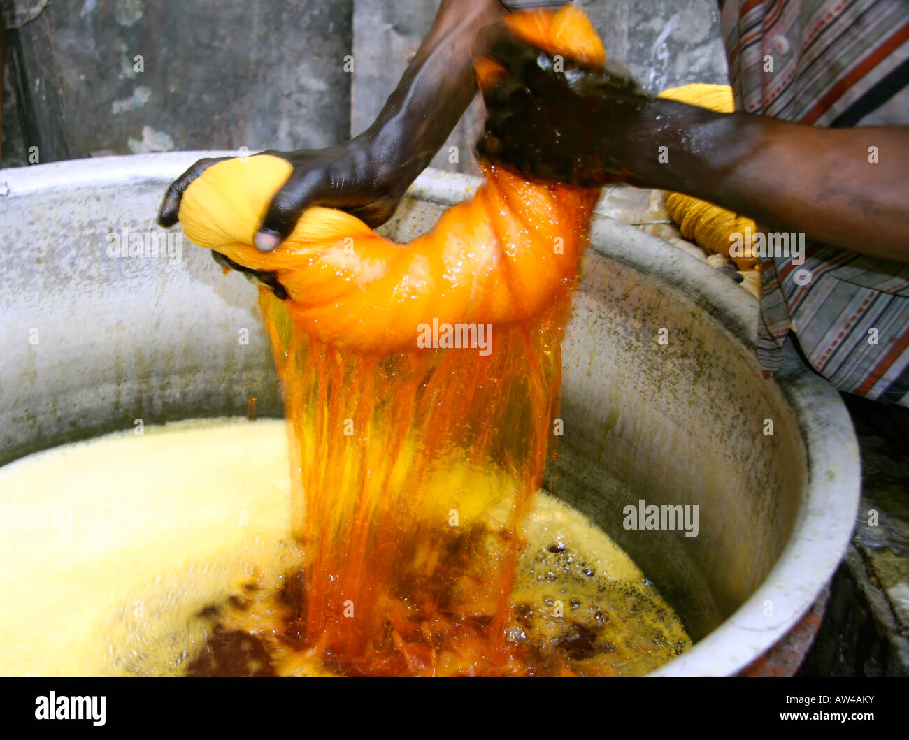 man wringing cloth during dyeing delhi india Stock Photo